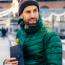 Man in green jacket holding winter coffee