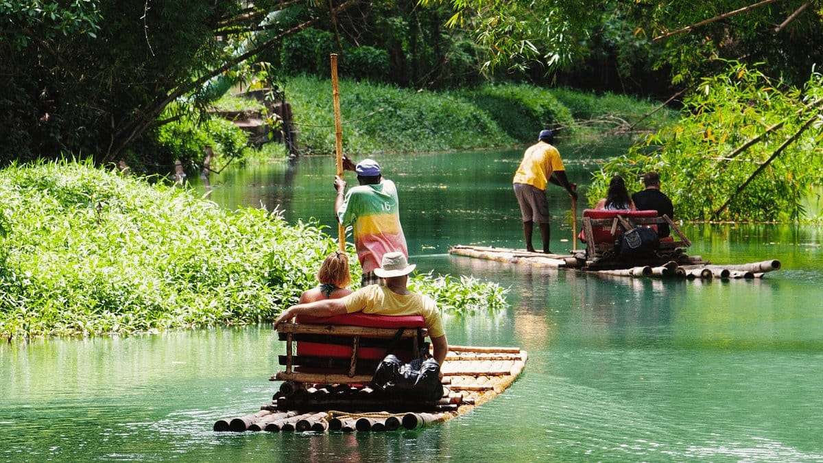 Tourists experiencing peaceful river rafting in Jamaica