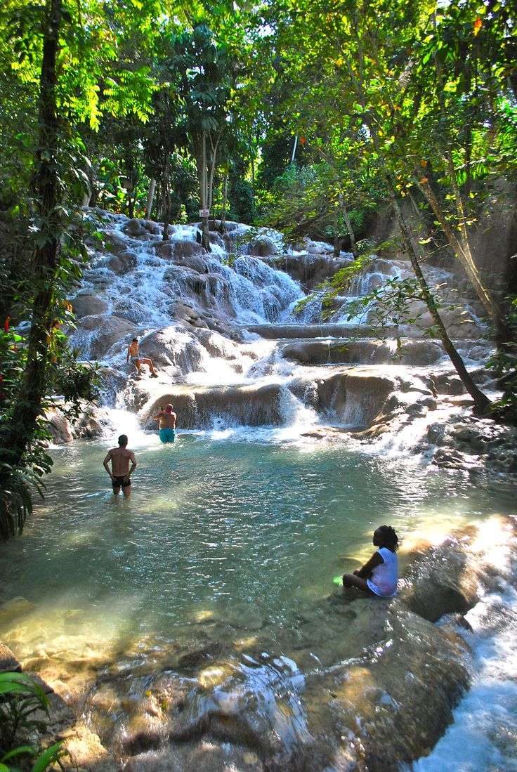 Visitors climbing Dunn's River Falls in Jamaica