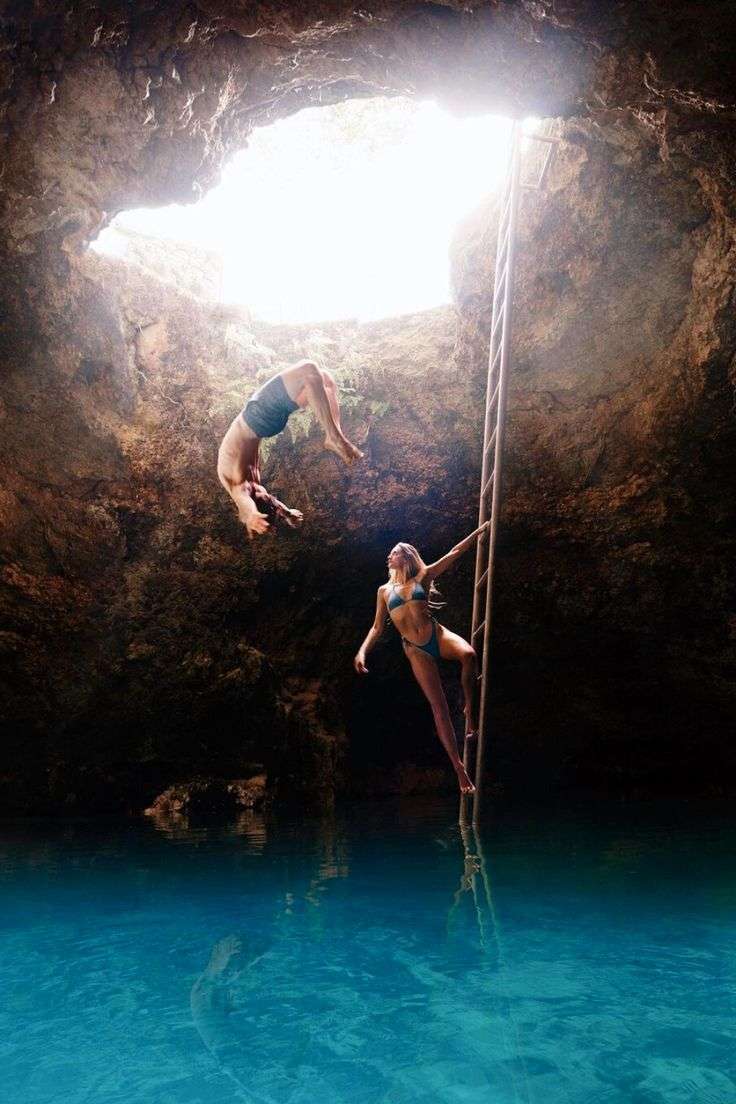 People diving inside the Blue Hole Mineral Spring located near Negril, Jamaica